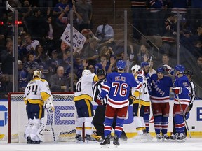 New York Rangers Jesper Fast (17) is congratulated by teammates after scoring a goal on Nashville Predators goalie Juuse Saros (74) in the first period of an NHL hockey game, Saturday, Oct. 21, 2017, in New York. (AP Photo/Adam Hunger)