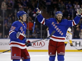 New York Rangers' Jimmy Vesey (26) celebrates scoring an empty net goal with teammate Kevin Hayes in the third period of an NHL hockey game against the Nashville Predators, Saturday, Oct. 21, 2017, in New York. The Rangers won 4-2. (AP Photo/Adam Hunger)