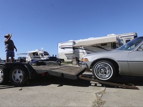 Glenn Martin, left, and Marty Vaughn of Mobile, Ala., help Al Manning load up his vehicle as they prepare to leave Biloxi, Miss., on Friday, Oct. 6, 2017.  Gulf Coast residents were bracing Friday for a fast-moving blast of wind, heavy rain and rising water as Tropical Storm Nate threatened to reach hurricane strength before a weekend landfall.   (John Fitzhugh/The Sun Herald via AP)