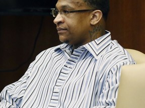 Quinton Tellis, 29, charged with burning 19-year-old Jessica Chambers to death almost three years ago, looks away as he sits in a Batesville, Miss., courtroom, waiting for his trial to begin, Tuesday, Oct. 10, 2017. Chambers was on fire when she was discovered, next to her burning car along a back road in Courtland, Miss., Dec. 6, 2014. Tellis has pleaded not guilty to murder. (AP Photo/Rogelio V. Solis, Pool)