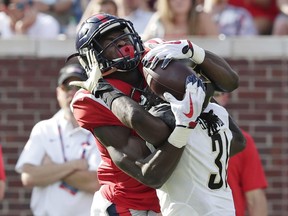 Mississippi wide receiver D.K. Metcalf (14) pulls in a pass reception over the defense of Vanderbilt cornerback Tre Herndon (31) in the first half of an NCAA college football game in Oxford, Miss., Saturday, Oct. 14, 2017. (AP Photo/Rogelio V. Solis)
