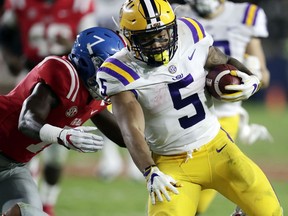 LSU running back Derrius Guice (5) runs through Mississippi defenders for a long gain in the second half of an NCAA college football game in Oxford, Miss., Saturday, Oct. 21, 2017. No. 24 LSU won 40-24. (AP Photo/Rogelio V. Solis)