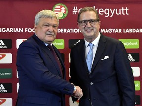 New head coach of the Hungarian national soccer team Georges Leekens of Belgium, right, and President of the Hungarian Soccer Federation (MLSZ) Sandor Csanyi shake hands prior to Leekens' press conference in the training centre in Telki, 19 kms west of Budapest, Hungary, Monday, Oct. 30, 2017. (Tibor Illyes/MTI via AP)