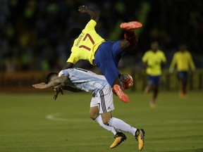 Argentina's Nicolas Otamendi, left, fights for the ball against Ecuador's Roberto Ordonez during their 2018 World Cup qualifying soccer match at the Atahualpa Olympic Stadium in Quito, Ecuador, Tuesday, Oct. 10, 2017. (AP Photo/Dolores Ochoa)