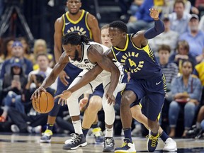 Indiana Pacers guard Victor Oladipo (4) knocks the ball away from Brooklyn Nets forward DeMarre Carroll during the first half of an NBA basketball game in Indianapolis, Wednesday, Oct. 18, 2017. (AP Photo/Michael Conroy)