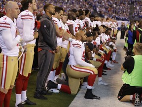 Members of the San Francisco 49ers kneel during the playing of the national anthem before an NFL football game against the Indianapolis Colts, Sunday, Oct. 8, 2017, in Indianapolis. Vice President Mike Pence left the 49ers-Colts game after about a dozen San Francisco players took a knee during the national anthem Sunday. (AP Photo/Michael Conroy)