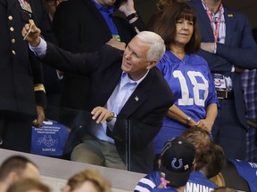 Vice President Mike Pence takes a photo with a fan before an NFL football game between the Indianapolis Colts and the San Francisco 49ers, Sunday, Oct. 8, 2017, in Indianapolis. (AP Photo/Michael Conroy)