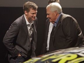 Dale Earnhardt Jr, left, talks with team owner Rick Hendrick after the unveiling of the team's cars for the NASCAR Cup Series' 2018 season during an event in Charlotte, N.C., Thursday, Oct. 5, 2017. (AP Photo/Chuck Burton)