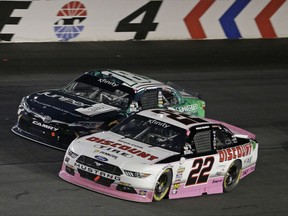 Ryan Blaney (22) races Daniel Suarez (18) out of Turn 4 during an Xfinity Series auto race at Charlotte Motor Speedway in Concord, N.C., Saturday, Oct. 7, 2017. (AP Photo/Chuck Burton)