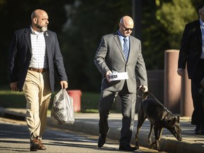 Former Navy Seal James Hatch, center, arrives at the Fort Bragg courthouse to testify in the Army Sgt. Bowe Bergdahl's sentencing hearing on Wednesday, Oct. 25, 2017, on Fort Bragg, N.C. Bergdahl, who walked off his base in Afghanistan in 2009 and was held by the Taliban for five years, pleaded guilty to desertion and misbehavior before the enemy last week and faces a maximum of life in prison..Hatch suffered a career-ending injury during a mission to find Bergdahl. (Andrew Craft /The Fayetteville Observer via AP)