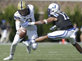 Duke's Jordan Hayes (13) reaches for Pittsburgh quarterback Ben DiNucci (3) during the first half of an NCAA college football game in Durham, N.C., Saturday, Oct. 21, 2017. (AP Photo/Gerry Broome)