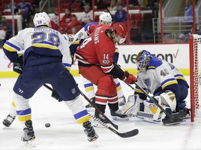 St. Louis Blues' Kyle Brodziak (28) and goalie Carter Hutton (40) defend against Carolina Hurricanes' Justin Williams (14) during the second period of an NHL hockey game in Raleigh, N.C., Friday, Oct. 27, 2017. (AP Photo/Gerry Broome)