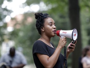 In this photo taken Thursday, Aug. 31, 2017 University of North Carolina student Gabrielle Johnson speaks to a crowd gathered at a Confederate monument protest on campus in Chapel Hill, N.C. The debate over removing Confederate symbols from college campuses has prompted fresh questions about buildings named for benefactors whose ties to slavery or white supremacy may have flown under the radar in decades past. (AP Photo/Gerry Broome)