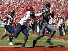 North Carolina State wide receiver Stephen Louis (12) beats Syracuse defensive back Evan Foster (14) for a 20-yard touchdown reception during the first half  of an NCAA college football game at Carter-Finley Stadium in Raleigh, N.C., Saturday, Sept. 30, 2017. (Ethan Hyman/The News & Observer via AP)