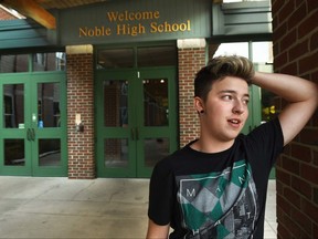 FILE - In this undated file photo, Stiles Zuschlag, a transgender teen, stands outside Noble High School in North Berwick, Maine. The Maine teen who was crowned homecoming king at his new school says he wants to use the attention to spread love and tolerance. (Deb Cram/Portsmouth Herald via AP, File)