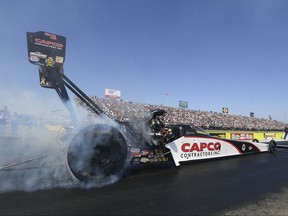 In this photo provided by the NHRA, Steve Torrence races to the Top Fuel No. 1 qualifier Saturday, Oct. 14, 2017, at the annual AAA Texas NHRA FallNationals in Ennis, Texas. (Jerry Foss/NHRA via AP)