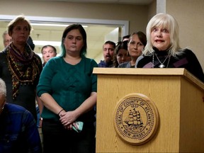 In this Jan. 24, 2017, Gail Biel, right, of Linwood, speaks out against Atlantic County Freeholder John Carman because of a meme he posted on Facebook during the Women's March on Washington, as others listen during freeholder meeting in Northfield, N.J. Democrat Ashley Bennett is challenging the Republican, who is seeking his second three-year term on the Atlantic County Board of Freeholders in a Nov. 7 election. (Edward Lea /The Press of Atlantic City via AP)