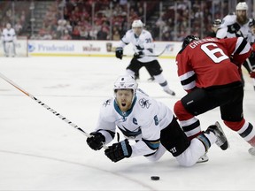 San Jose Sharks center Joe Pavelski (8) collides with New Jersey Devils defenseman Andy Greene (6) during the first period of an NHL hockey game, Friday, Oct. 20, 2017, in Newark, N.J. (AP Photo/Julio Cortez)