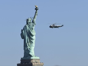 Marine One, with President Donald Trump on board, flies past the Statue of Liberty, as it heads to the Liberty Park landing zone in Jersey City, N.J., Sunday, Oct. 1, 2017. Trump is heading to attend the Presidents Cup golf tournament. (AP Photo/Susan Walsh)