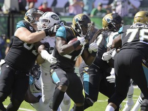 Jacksonville Jaguars' Leonard Fournette, center, runs the ball during the first half of an NFL football game against the New York Jets, Sunday, Oct. 1, 2017, in East Rutherford, N.J. (AP Photo/Bill Kostroun)