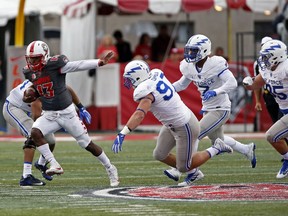 New Mexico quarterback Lamar Jordan (13) runs for yardage past the Air Force defense during the first half of an NCAA college football game in Albuquerque, N.M., Saturday, Sep. 30, 2017. (AP Photo/Andres Leighton)