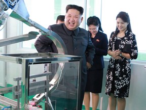 In this undated photo provided Sunday, Oct. 29, 2017, by the North Korean government,  North Korean leader Kim Jong Un, center, visits a cosmetics factory in Pyongyang, North Korea.