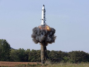 FILE - In this undated file photo distributed by the North Korean government on May 22, 2017, a solid-fuel "Pukguksong-2" missile lifts off during its launch test at an undisclosed location in North Korea