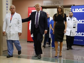 President Donald Trump and first lady Melania Trump walk with surgeon Dr. John Fildes at the University Medical Center after meeting with survivors of the mass shooting Wednesday, Oct. 4, 2017, in Las Vegas. (AP Photo/Evan Vucci)