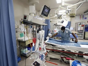 Charlie Fletcher, an environmental services worker, organizes items in the trauma unit at the University Medical Center, Tuesday, Oct. 3, 2017, in Las Vegas. A man opened fire at a country music concert on Sunday. It was the deadliest mass shooting in modern U.S. history and scores of people remained in critical condition Tuesday. The University Medical Center was one of many hospitals that were overflowing. (AP Photo/Gregory Bull)