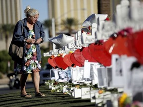 Nancy Hardy, of Las Vegas, cries as she walks among crosses placed in honor of those killed in the recent mass shooting Friday, Oct. 6, 2017, in Las Vegas. A gunman opened fire on an outdoor music concert on Sunday killing dozens and injuring hundreds.  (AP Photo/Gregory Bull)