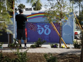 A mural honoring 58 victims adorns a building at the Las Vegas Community Healing Garden, Monday, Oct. 16, 2017, in Las Vegas. The garden was built as a memorial for the victims of the recent mass shooting in Las Vegas. (AP Photo/John Locher)
