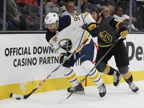 Buffalo Sabres right wing Justin Bailey, left, skates around Vegas Golden Knights defenseman Colin Miller during the second period of an NHL hockey game Tuesday, Oct. 17, 2017, in Las Vegas. (AP Photo/John Locher)