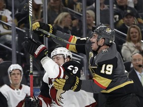 Vegas Golden Knights right wing Reilly Smith (19) and Arizona Coyotes defenseman Oliver Ekman-Larsson battle for the puck during the first period of an NHL hockey game Tuesday, Oct. 10, 2017, in Las Vegas. (AP Photo/John Locher)
