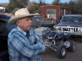 FILE - In this April 5, 2014 file photo, Cliven Bundy stands at the Bundy ranch near Bunkerville Nev. Two Idaho men pleaded guilty Monday, Oct. 23, 2017, to lesser charges and will avoid a third trial in Las Vegas for having assault-style weapons during a confrontation with federal agents near states' rights figure Bundy's ranch in 2014. (John Locher /Las Vegas Review-Journal via AP, File)