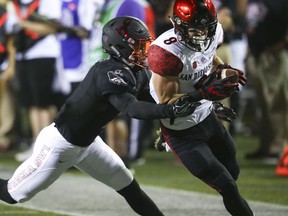 UNLV's Jericho Flowers tries to tackle San Diego State's Quest Truxton (8) during a football game in Las Vegas on Saturday, Oct. 7, 2017. (Chase Stevens/Las Vegas Review-Journal via AP)