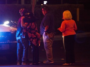 People embrace after arriving at Metro Headquarters to check on loved ones early Monday, Oct. 2, 2017, after a mass shooting at a music festival on the Las Vegas Strip Sunday. (Yasmina Chavez/Las Vegas Sun via AP)