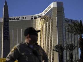 FILE - In this Tuesday, Oct. 3, 2017 file photo, a Las Vegas police officer stands by a blocked off area near the Mandalay Bay casino in Las Vegas. On Sunday, Oct. 1, Stephen Paddock opened fire on the Route 91 Harvest Festival killing dozens and wounding hundreds.  Paddock spent hours in casinos. and was known for betting big on video poker and staring down fellow gamblers.  There is no indication, though, that any particular grievance set him off. But details that have surfaced so far about the one-time IRS agent and son of a notorious bank robber, are clues, at least, to his mindset.  (AP Photo/John Locher, File)