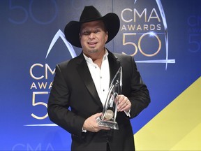 FILE - In this Nov. 2, 2016 file photo, Garth Brooks, winner of the award for entertainer of the year, poses in the press room at the 50th annual CMA Awards at the Bridgestone Arena  in Nashville, Tenn. Fans at the first big concert at Atlanta's gleaming new sports arena say a screeching sound made it impossible to hear  Garth Brooks' lyrics, even though they knew all the words to his songs. WSB-TV reports some fans left Thursday, Oct. 12, 2017  show early. Others are asking for refunds.  (Photo by Evan Agostini/Invision/AP, File)