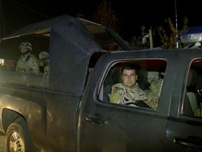 This image made from a video provided by RUDAW TV shows what the Irbil-based Kurdish broadcaster says are Peshmerga fighters and volunteers arriving on military trucks in Kirkuk, Iraq, Monday, Oct. 16, 2017. (RUDAW TV via AP)
