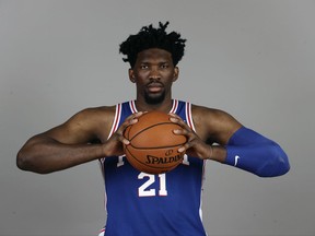 FILE - In this Sept. 25, 2017, file photo, Philadelphia 76ers' Joel Embiid poses for a photograph during media day at the NBA basketball team's practice facility, in Camden, N.J. Philadelphia bet its future on Embiid, signing one of the more talented, yet injury-prone, players in the game to a league maximum contract extension. A person familiar with the situation tells The Associated Press that Embiid and the Sixers have agreed on a $148 million, five-year extension and it could increase even more if the 7-foot center reaches certain incentives. The person spoke on condition of anonymity Monday, Oct. 9, 2017, because the contract has not been officially announced.(AP Photo/Matt Rourke, File)
