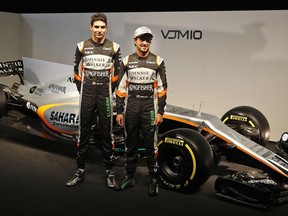 FILE - In this Wednesday, Feb. 22, 2017 file photo, Force India driver Sergio Perez of Mexico, right, and Force India driver Esteban Ocon of France pose at the launch of the new Force India F1 car, VJM10, at the Silverstone racetrack in Towcester, England. One of the bitter rivalries of the Formula One season has lived in the cockpits of the pink Force India cars. Crashes have led to a season of bickering between Mexico's Sergio Perez and France's Esteban Ocon. The drivers say they respect each other heading in the Mexican Grand Prix. But Ocon will also be driving in front of a Mexican crowd that could give him a rough welcome. Ocon says he's received death threats during the season. (AP Photo/Frank Augstein, File)