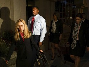 FILE - In this Thursday, Sept. 14, 2017 file photo, Ma'lik Richmond, center, of Steubenville, walks out of a U.S. District Court with his attorney, Susan Stone, left, in Youngstown, Ohio. Youngstown State football coach Bo Pelini says Steubenville resident Ma'lik Richmond will be allowed to play football after settling a lawsuit Monday, Oct. 2, 2017 against the school for barring him from games this season after he made the team. (AP Photo/Dake Kang, File)