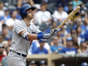 FILE - In this Sept. 3, 2017, file photo, Los Angeles Dodgers' Cody Bellinger watches his solo home run during the ninth inning of a baseball game against the San Diego Padres in San Diego. Bellinger will make his major league playoff debut this week after a remarkable rookie season with the Dodgers, who won 104 games and the NL West. The 22-year-old slugger set a league rookie record with 39 homers, and his veteran teammates think he can keep up his power stroke in the postseason. (AP Photo/Alex Gallardo, File)
