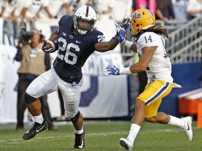 FILE - In this Saturday, Sept. 9, 2017 file photo, Penn State's Saquon Barkley (26) looks to stiff arm Pittsburgh's Avonte Maddox (14) during the second half of an NCAA college football game in State College, Pa. Penn State coach James Franklin sees the talent Northwestern has and the success the Wildcats have experienced under Pat Fitzgerald. Running back Saquon Barkley keeps padding his Heisman Trophy resume. (AP Photo/Chris Knight, File)