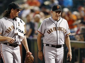 FILE - In this Sept. 27, 2017, file photo ,San Francisco Giants pitcher Jeff Samardzija, left, walks with pitching coach Dave Righetti, right, after Samardzija warmed up in the bullpen before a baseball game against the Arizona Diamondbacks in Phoenix. The Giants have reassigned Righetti from manager Bruce Bochy's field staff to special assistant to the general manager, working under Bobby Evans. (AP Photo/Ross D. Franklin, File)