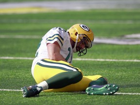 FILE - In this Oct. 15, 2017, file photo, Green Bay Packers quarterback Aaron Rodgers (12) lies on the ground after being hit by Minnesota Vikings outside linebacker Anthony Barr during an NFL football game in Minneapolis. Rodgers says in a post on social media that surgery on his broken collarbone went well. The two-time NFL MVP broke his right collarbone in the first quarter of Sunday's loss to the Minnesota Vikings after he was hit by linebacker Anthony Barr and landed hard on his throwing shoulder. (AP Photo/Jeff Haynes, File)