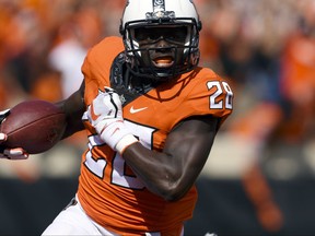 FILE - In this Sept. 23, 2017, file photo, Oklahoma State wide receiver James Washington (28) runs with the ball during an NCAA college football game against TCU in Stillwater, Okla. Oklahoma State faces Texas on Saturday. (AP Photo/Brody Schmidt, File)