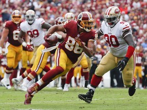 FILE - In this Sunday, Oct. 15, 2017 file photo, Washington Redskins tight end Jordan Reed (86) carries the ball during the first half of an NFL football game against the San Francisco 49ers in Landover, Md. Tight end Jordan Reed and defensive lineman Matt Ioannidis are among the injured Washington Redskins players who are expected to miss their upcoming game at the Seattle Seahawks on Sunday, Nov. 5, 2017. (AP Photo/Alex Brandon, File)