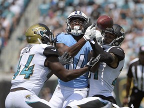 FILE - In this Sunday, Sept. 17, 2017 file photo, Jacksonville Jaguars outside linebacker Myles Jack (44) and cornerback A.J. Bouye, right, break up a pass intended for Tennessee Titans wide receiver Corey Davis during the first half of an NFL football game, Sunday, Sept. 17, 2017, in Jacksonville, Fla. Tennessee Titans finally might see rookie Corey Davis in a game again after the No. 5 pick overall missed the last five games. Davis practiced Monday, Oct. 30, 2017, even though he was limited, and says he's feeling good. (AP Photo/Phelan M. Ebenhack, File)