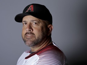 FILe - This is a 2016 file photo showing Ariel Prieto of the Arizona Diamondbacks baseball team. Diamondbacks coach Ariel Prieto says it was a mistake for him to wear an Apple Watch in the dugout during the NL wild-card game against Colorado. Prieto told reporters on Thursday, Oct. 5, 2017,  that he didn't use the watch for any illicit purpose and that it was on "airplane mode" during the game, a setting that shuts off any of the watch's communication abilities. (AP Photo/Chris Carlson, File)